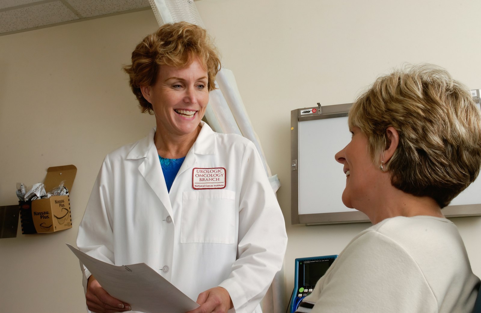 A clinician walking a patient through paperwork in an exam room